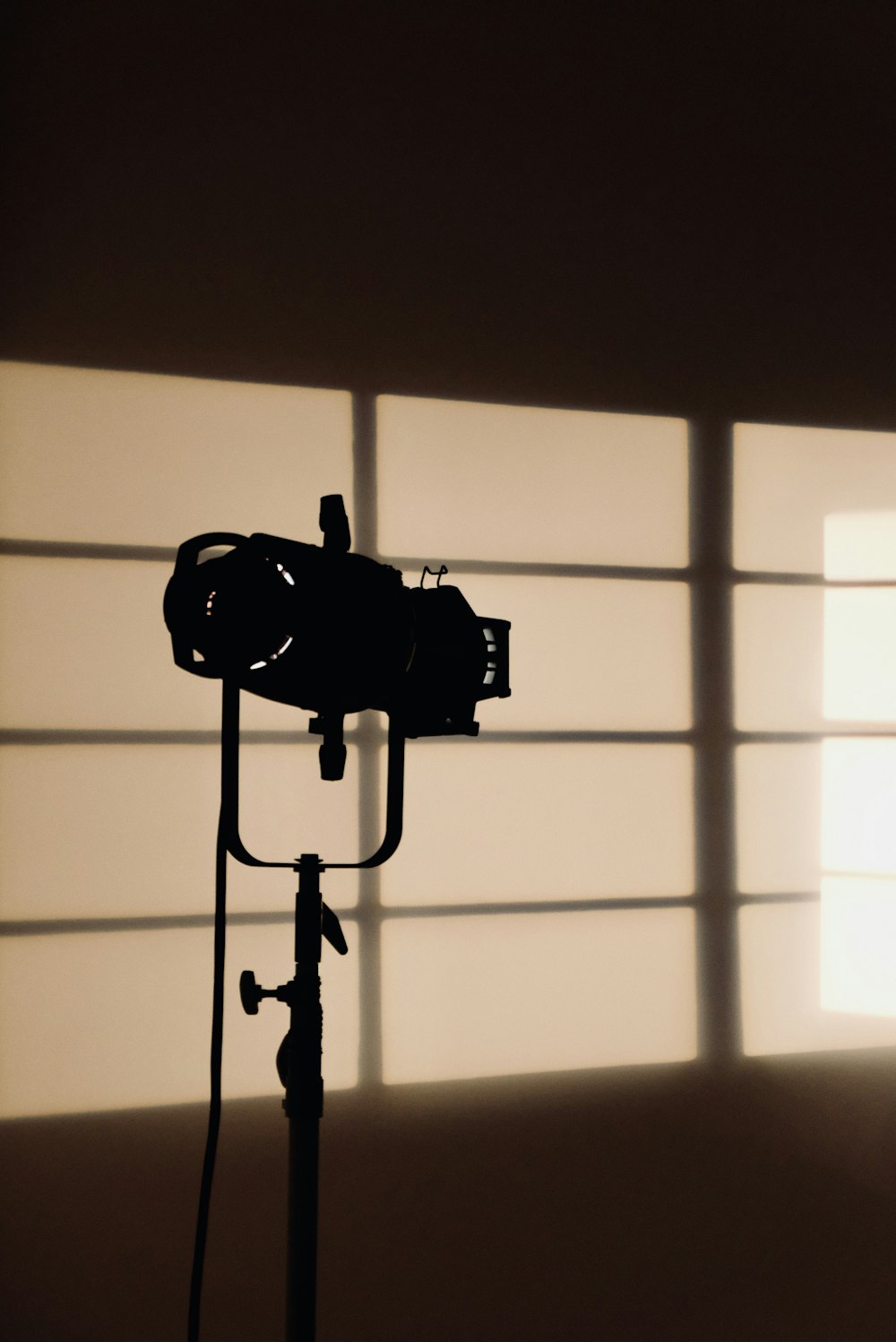 a camera on a tripod in front of a window