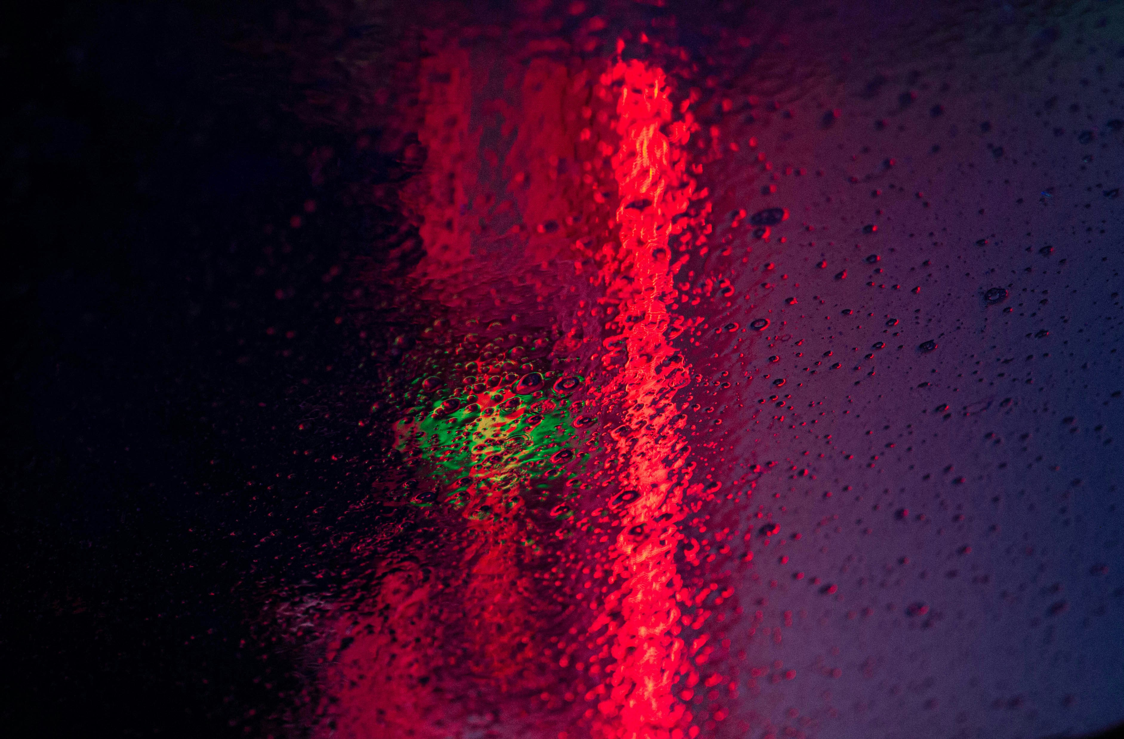 Red traffic light in rain