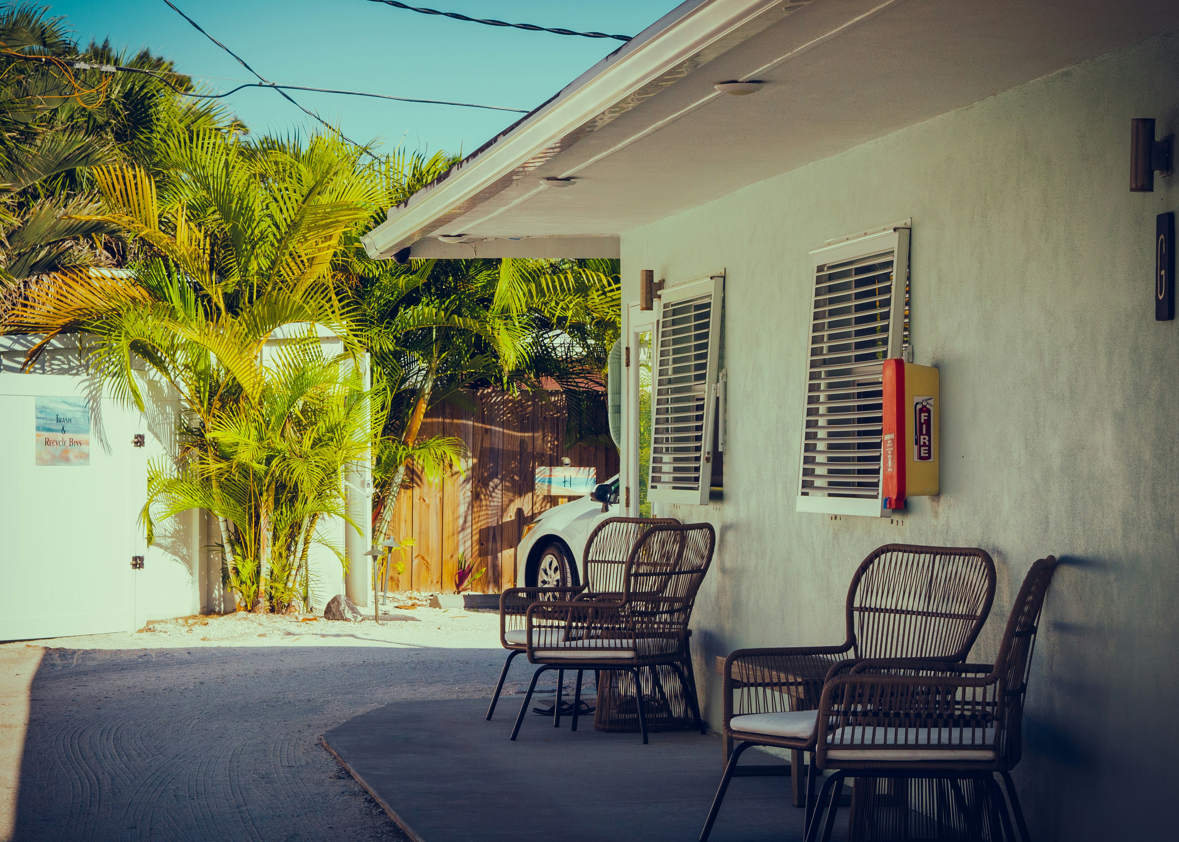 A group of chairs sitting outside of a house photo Free Home decor