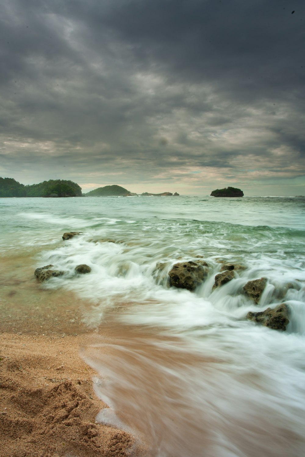 a beach that has some rocks in it