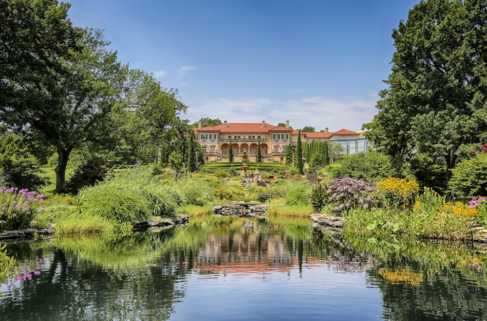 a large house sitting on top of a lush green hillside