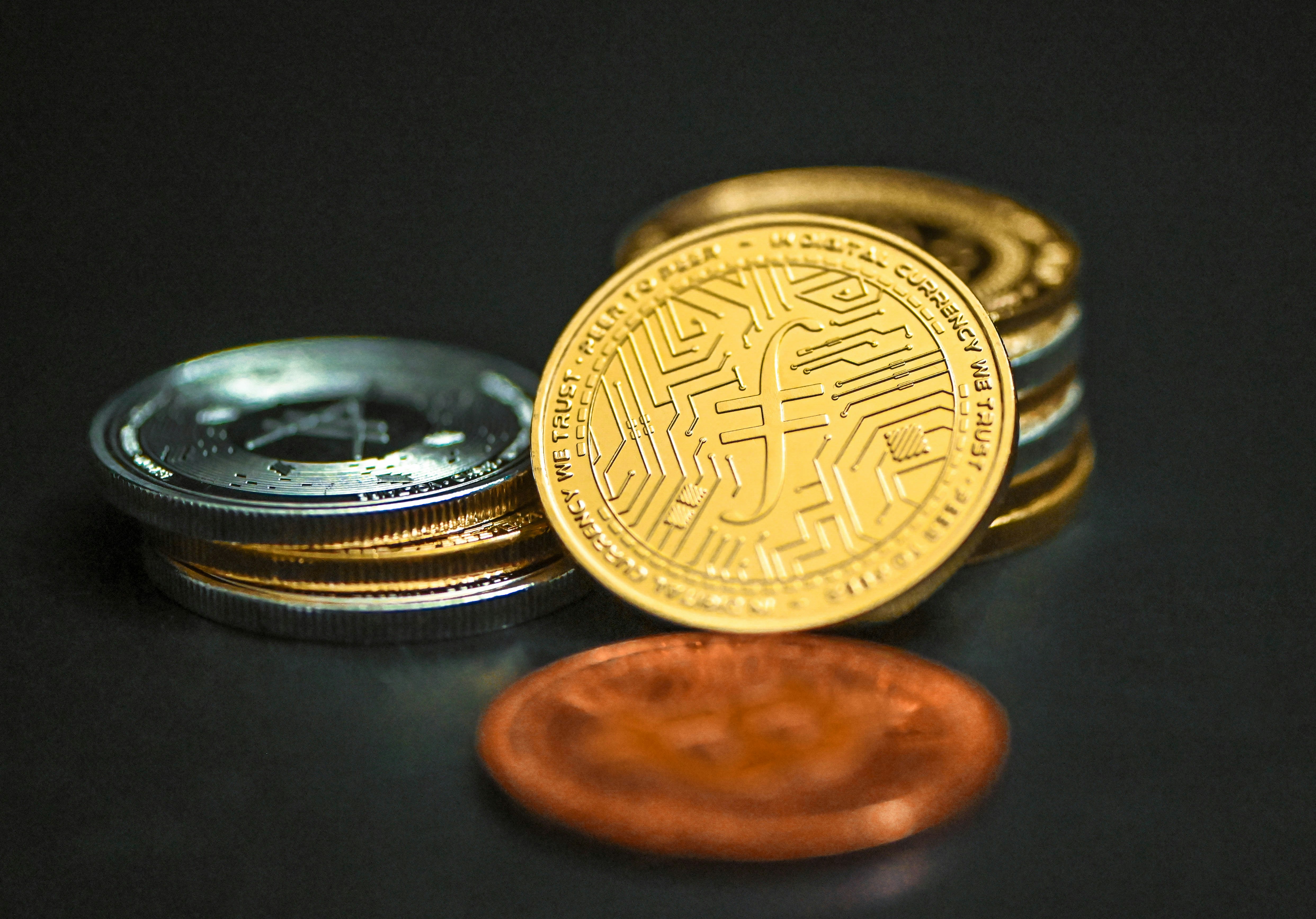 A gold Filecoin leaning on other coins