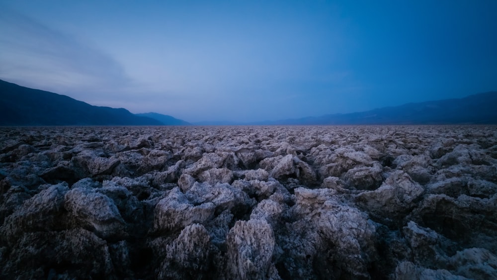 a vast expanse of rocky terrain with mountains in the distance