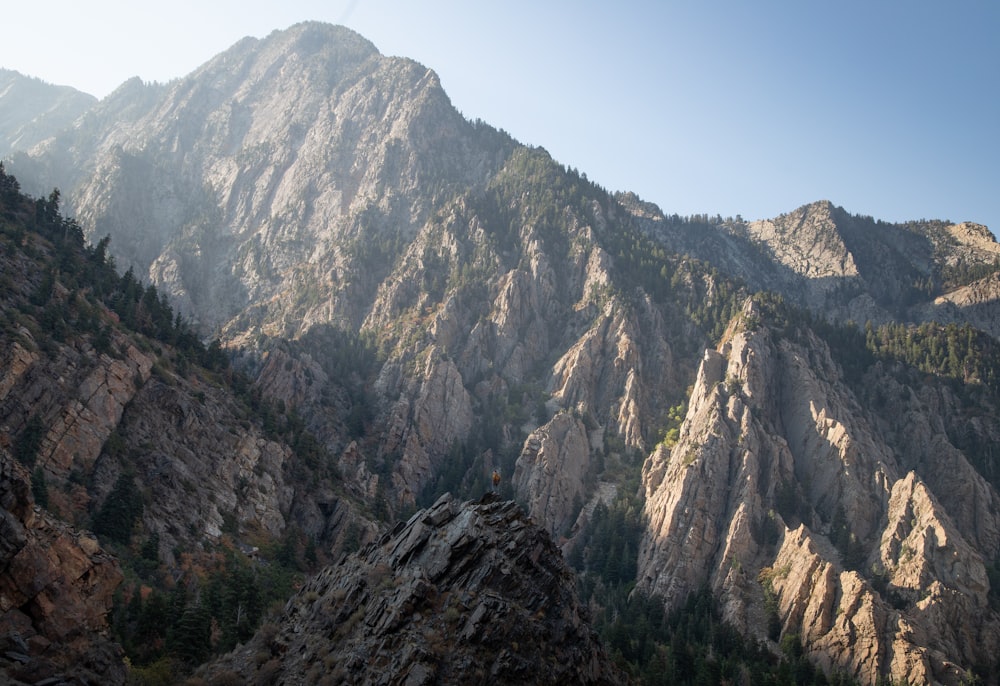 a view of a mountain range from the top of a hill