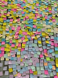 a large amount of post it notes on a wall