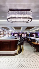 A sleek black and gold cocktail bar setup at an elegant social event.