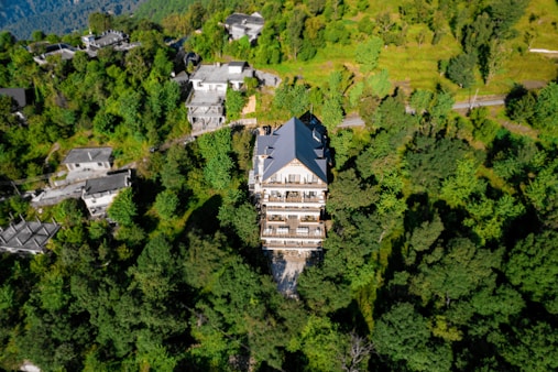 an aerial view of a building surrounded by trees