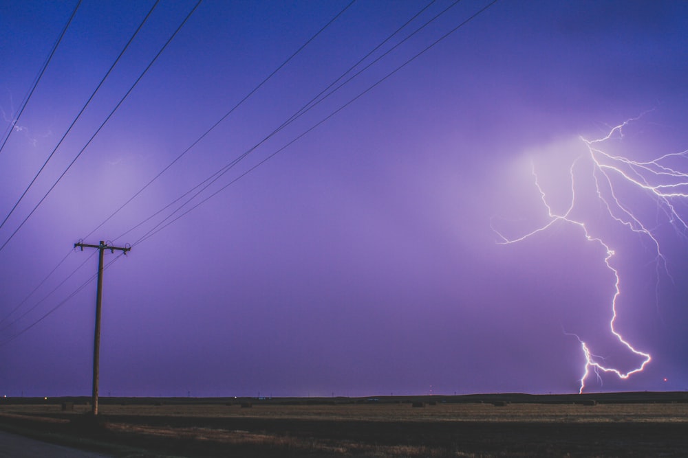 a purple sky with a lightning bolt in the middle of it