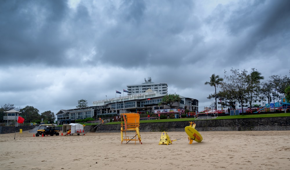 a beach with a lifeguard chair and a lifeguard tower in the background