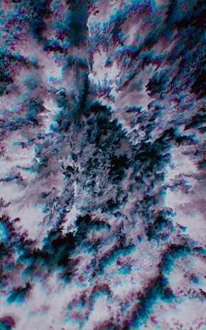 A dynamic abstract shape bursting with purple and black gradients symbolizing creative energy.