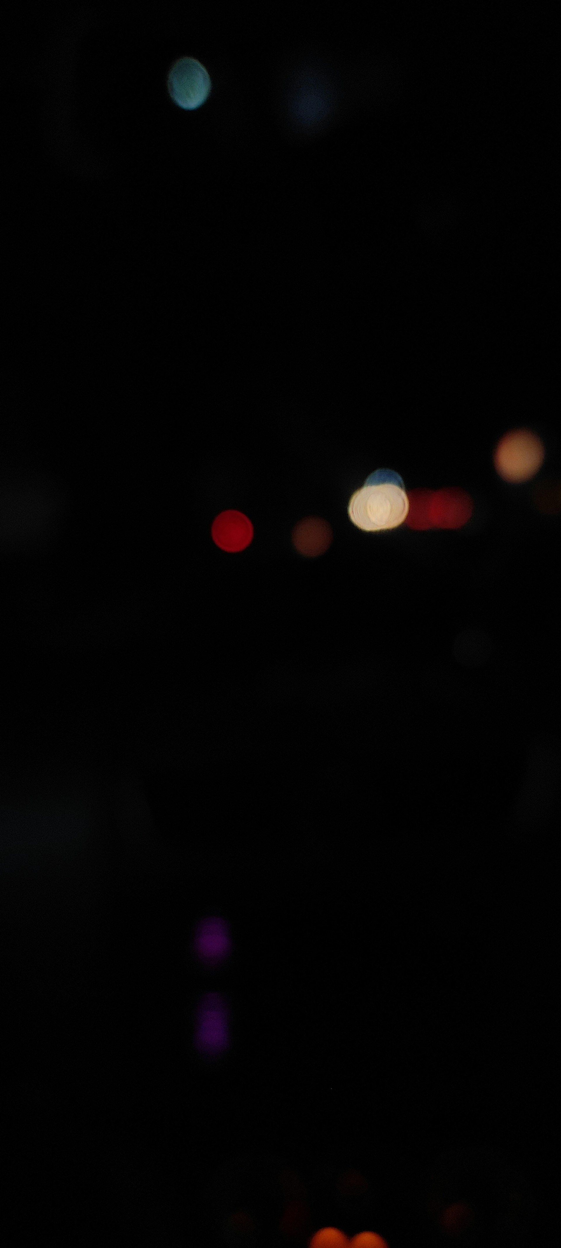 a blurry photo of a street light at night