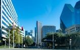 a city street with tall buildings in the background