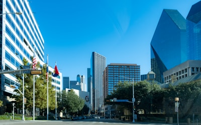 a city street with tall buildings in the background