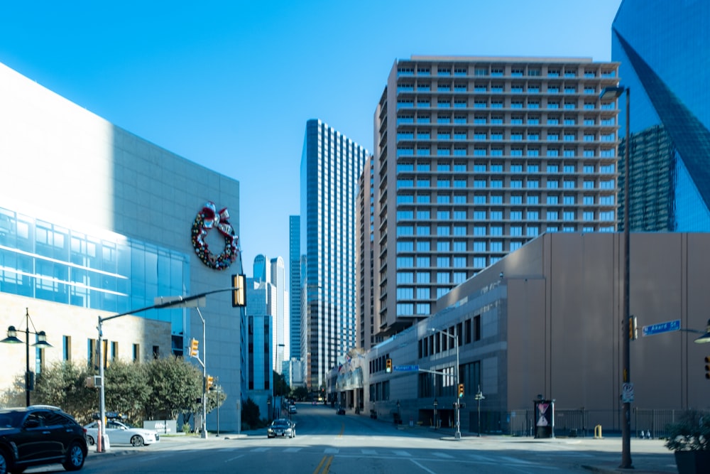 a city street with tall buildings and a clock