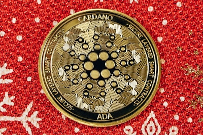 a close up of a gold medallion on a red background