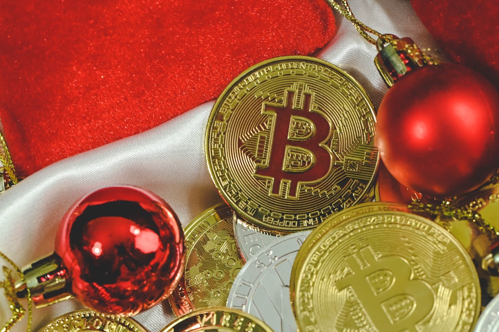 a pile of gold bitcoins and christmas ornaments