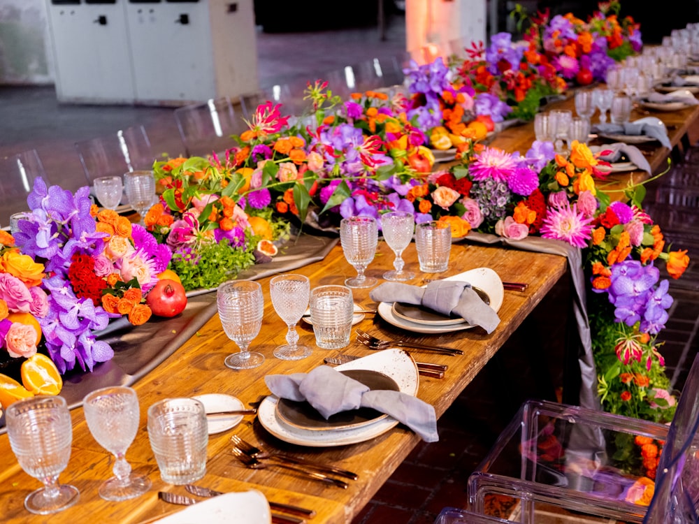 a long wooden table topped with lots of flowers