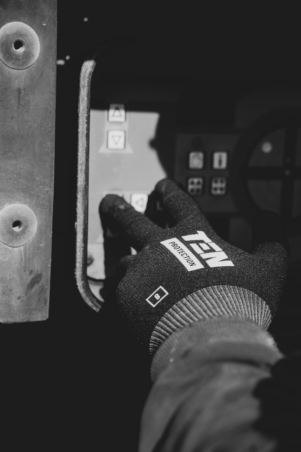 a person wearing a glove is working on a machine