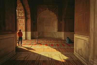 a person standing in a room with a rug on the floor