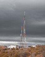a very tall tower sitting in the middle of a field