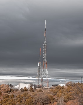 a very tall tower sitting in the middle of a field