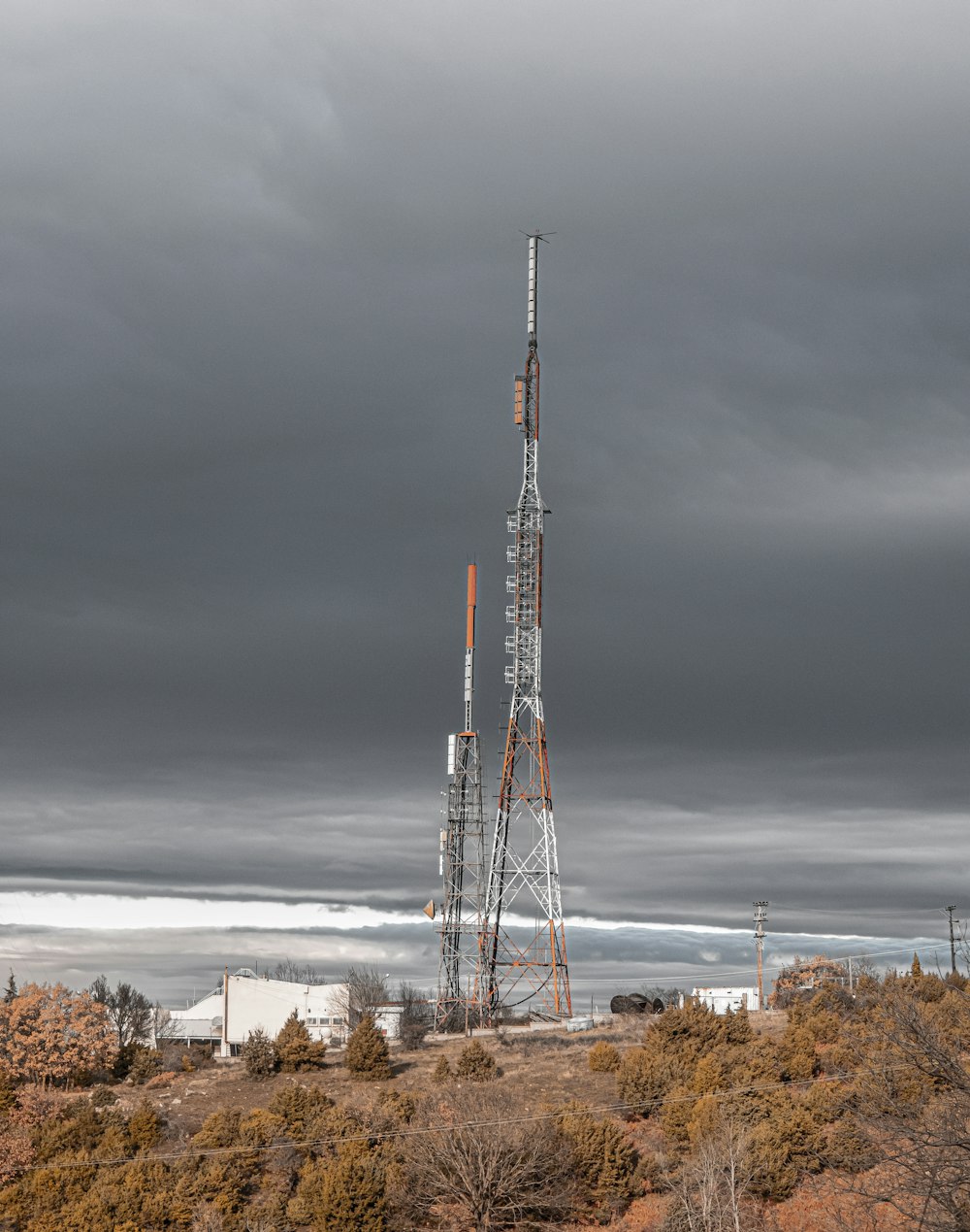 a very tall tower sitting in the middle of a field