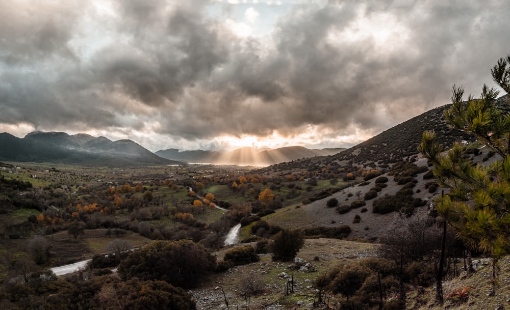 Le soleil brille à travers les nuages au-dessus des montagnes