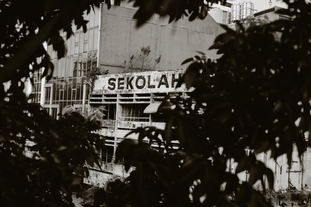 a black and white photo of a building with a sign on it