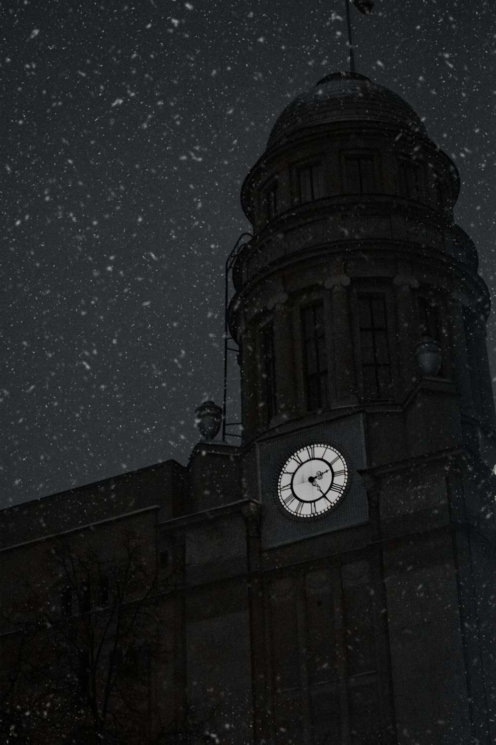 a clock on a building in the snow
