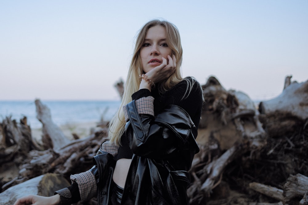 a woman in a black leather jacket posing for a picture