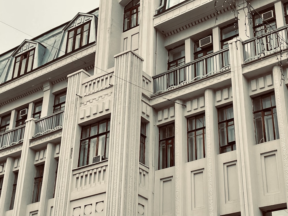 a tall white building with balconies and balconies