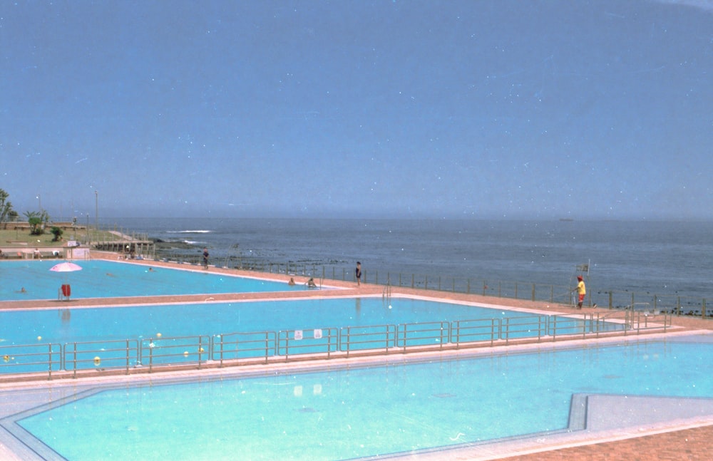a large swimming pool next to the ocean