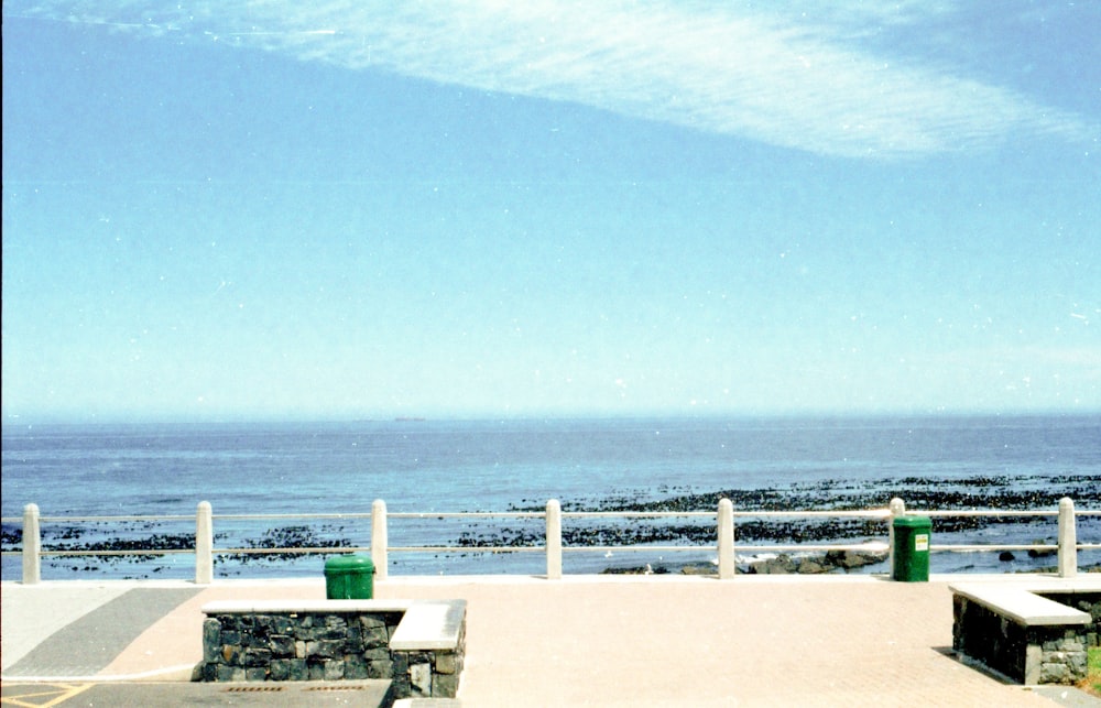 a couple of benches sitting next to a large body of water