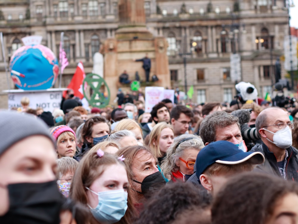 a large crowd of people wearing face masks