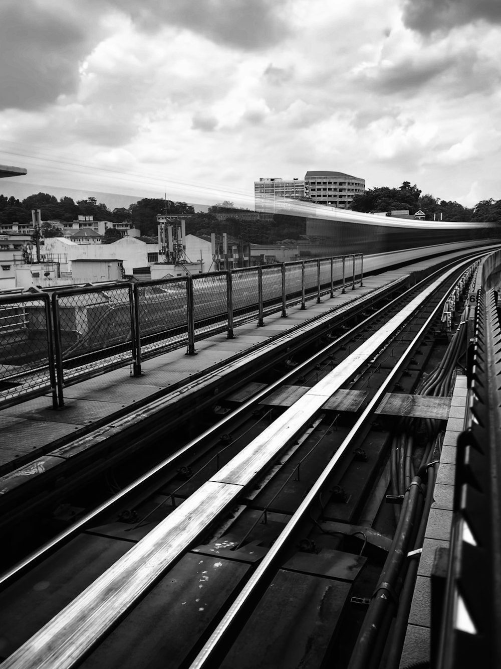 a black and white photo of a train track