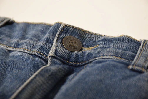 a button on the back of a pair of jeans