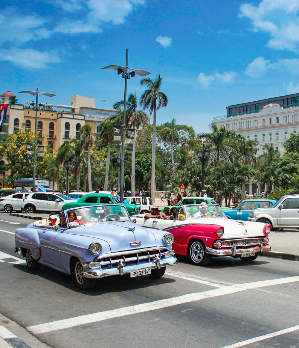 a couple of cars that are sitting in the street