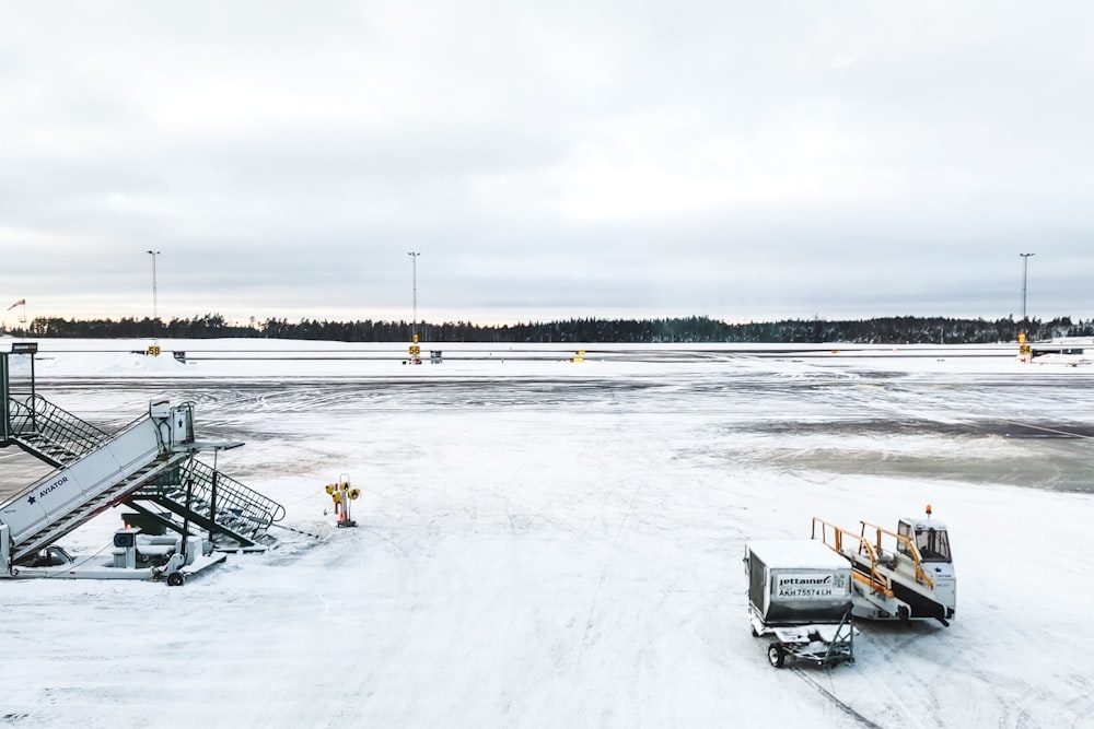 an airport tarmac covered in snow next to a runway