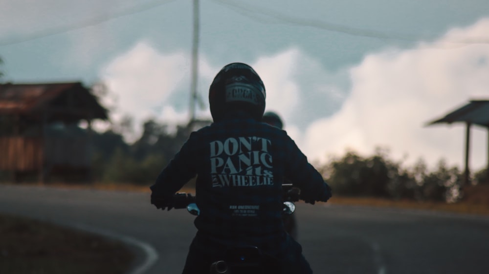 a person riding a motorcycle down a street