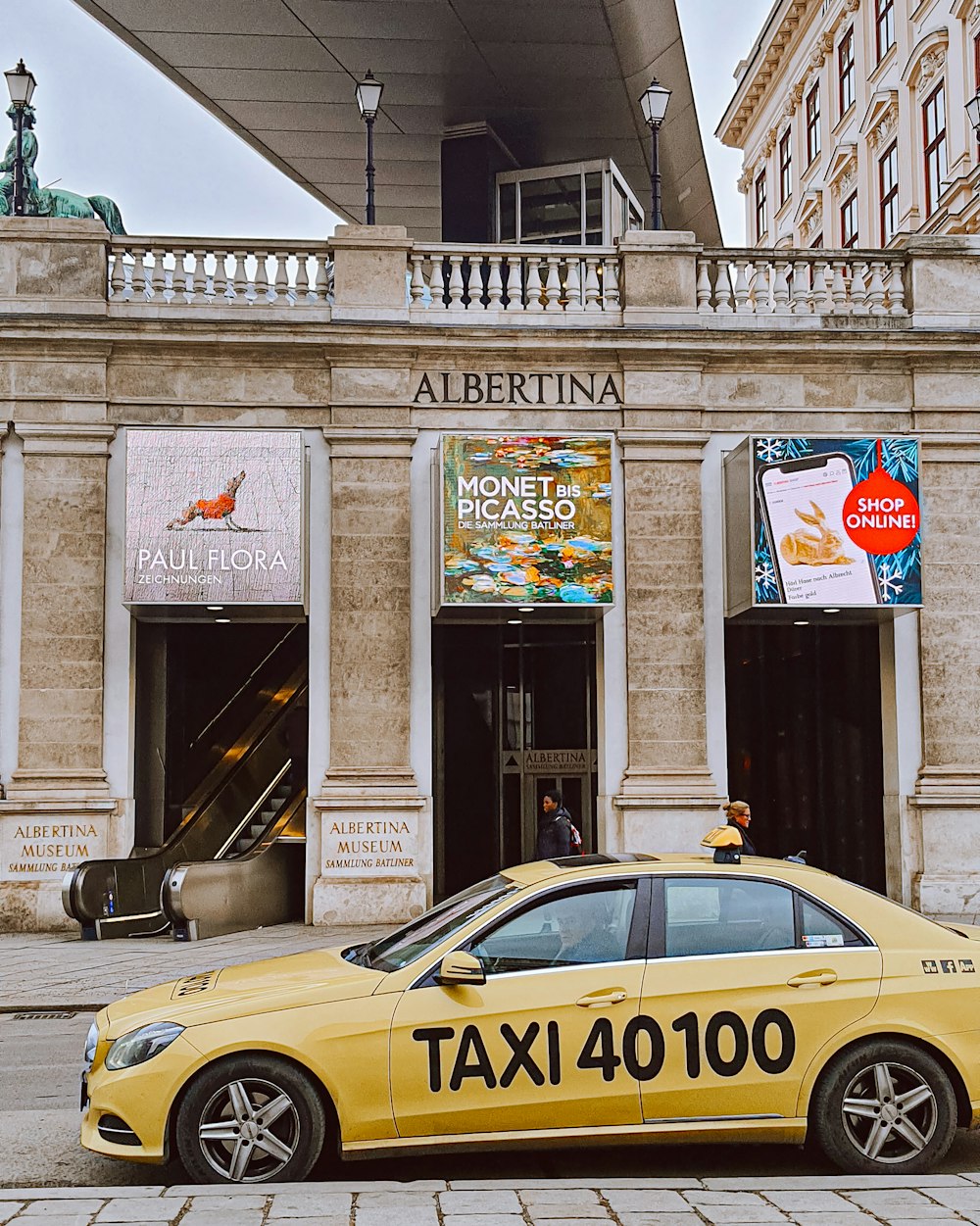 a taxi cab parked in front of a building