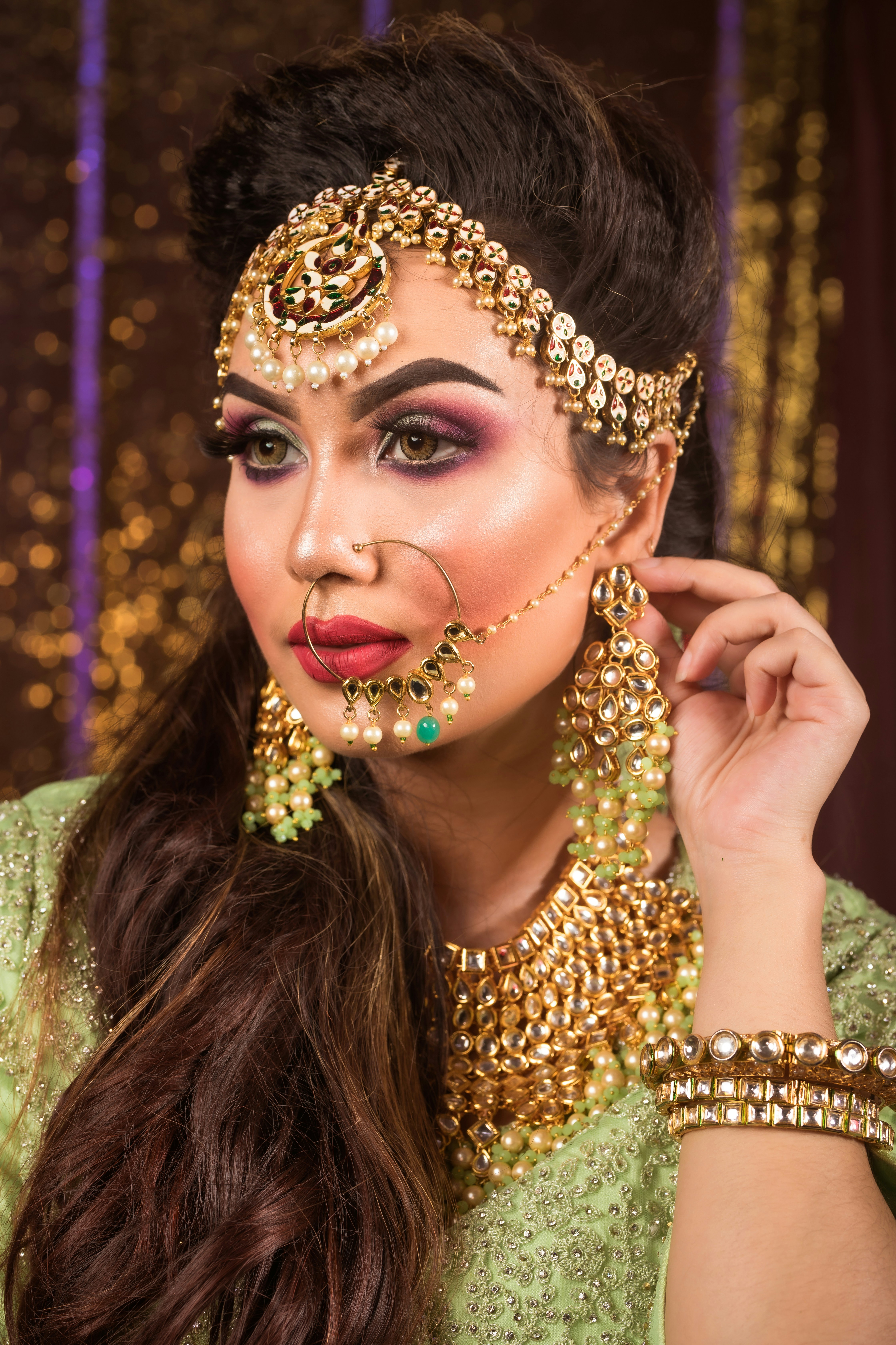 a woman wearing a gold and green costume