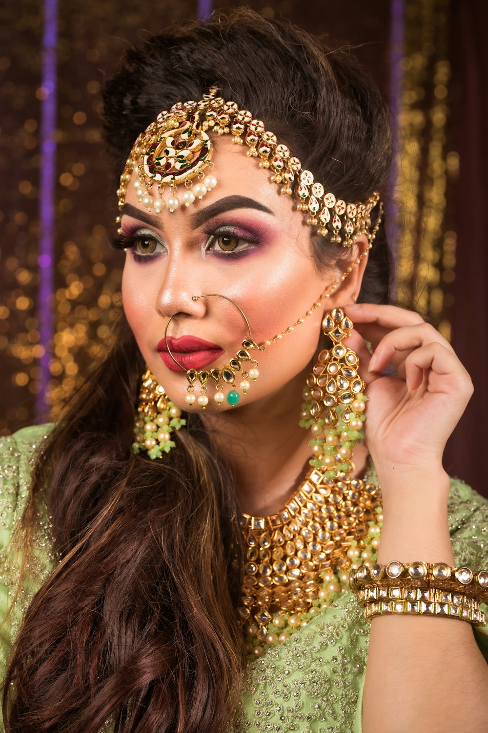 a woman wearing a gold and green costume