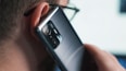 a close up of a person talking on a cell phone