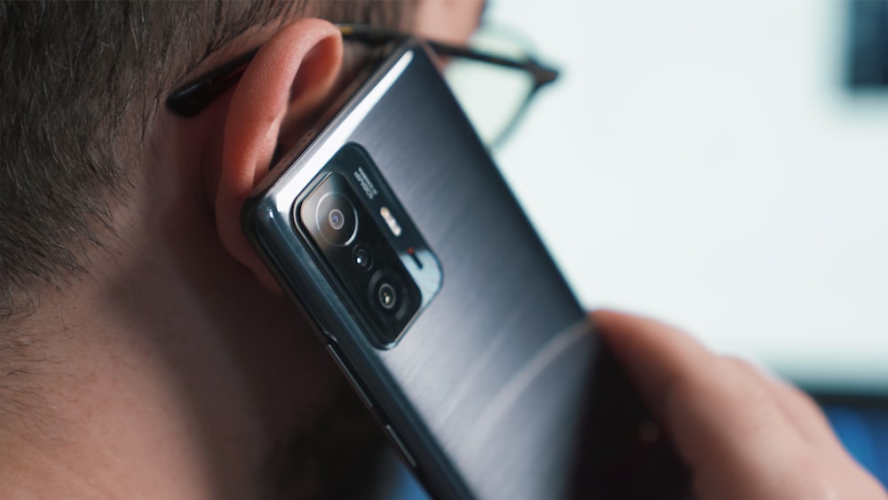 a close up of a person talking on a cell phone