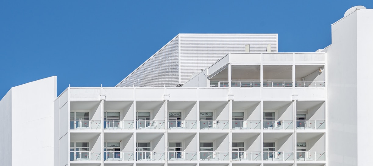 a tall white building with balconies and balconies