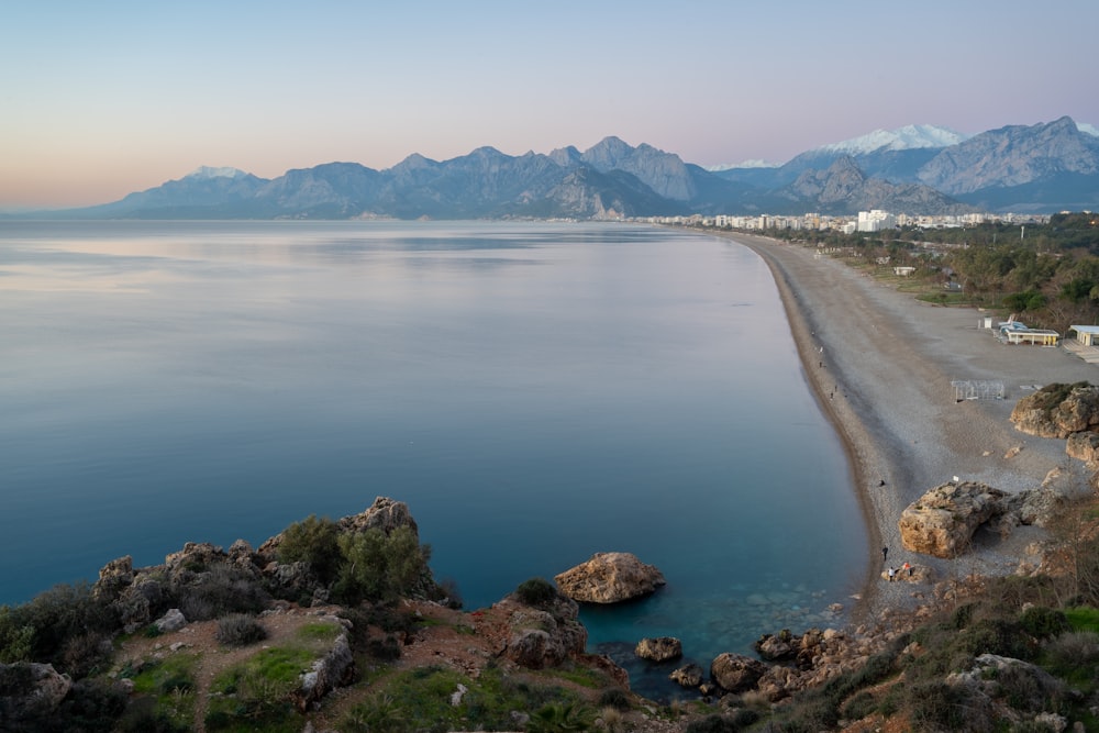 a large body of water with mountains in the background