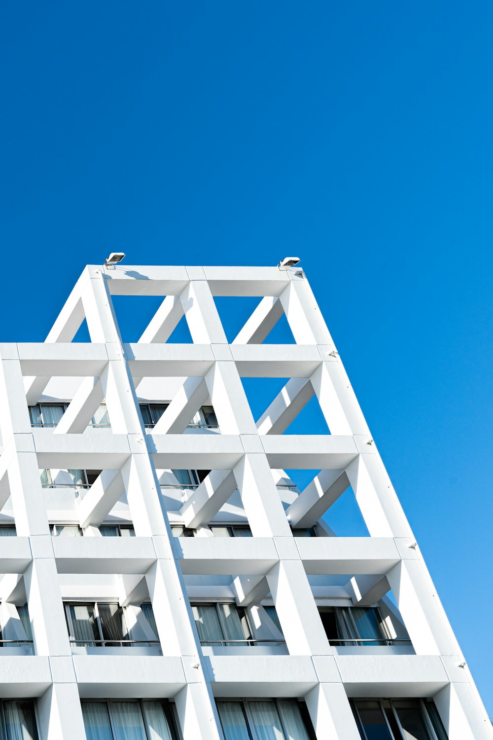 a tall white building with lots of windows