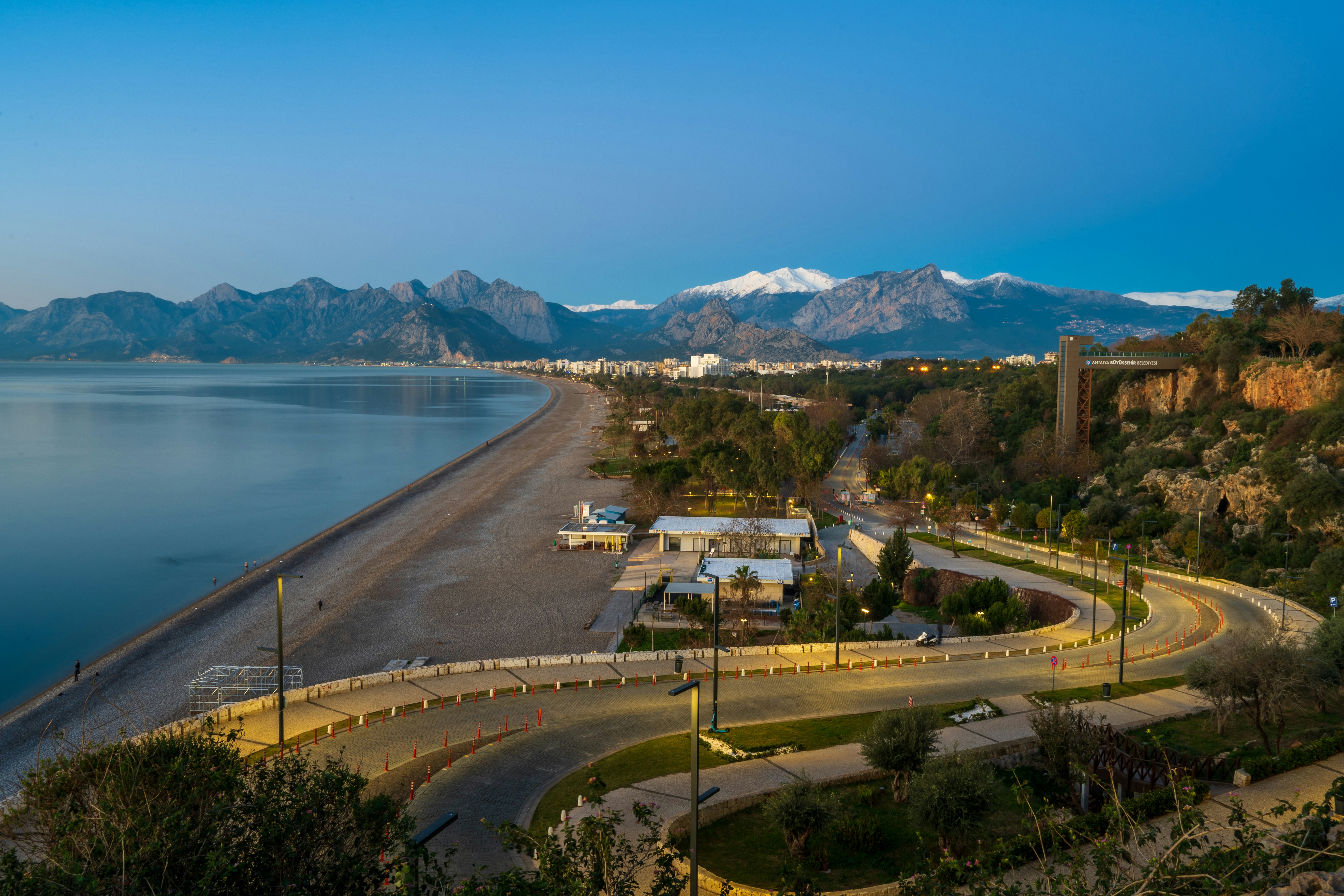 a scenic view of a beach with mountains in the background