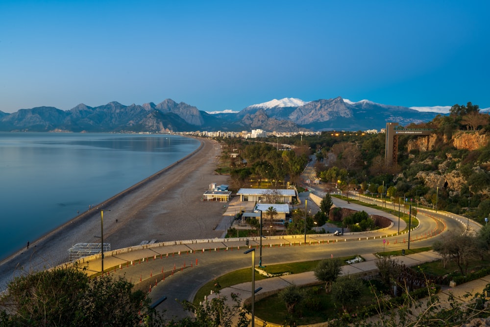 a scenic view of a beach with mountains in the background