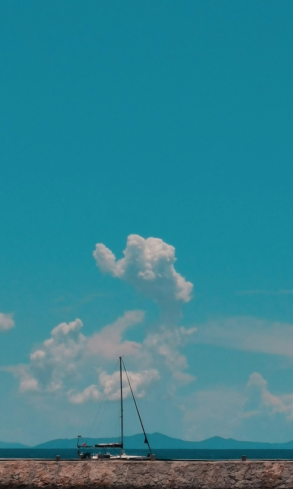 a sailboat floating on top of a body of water